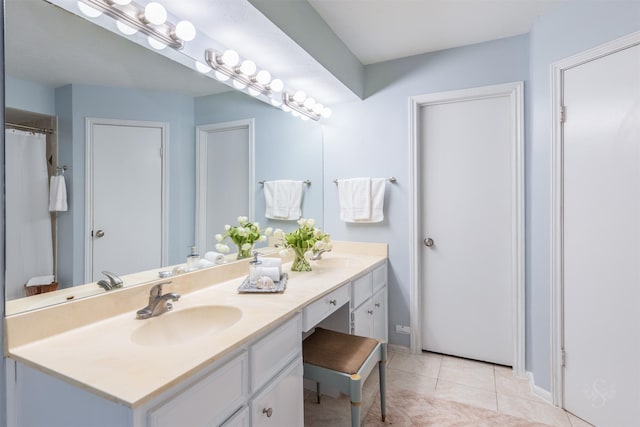 bathroom featuring double vanity, a sink, and tile patterned floors