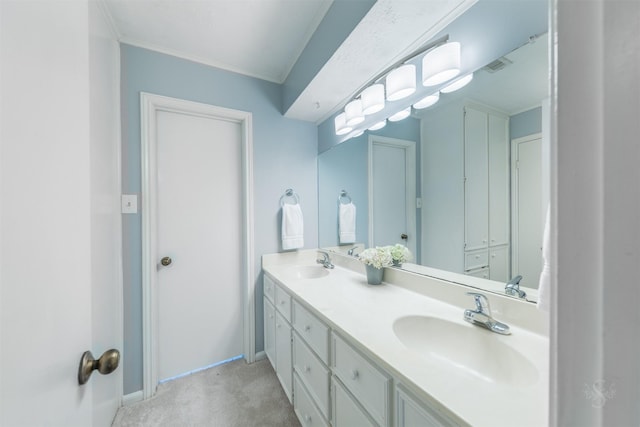 bathroom with double vanity, crown molding, visible vents, and a sink