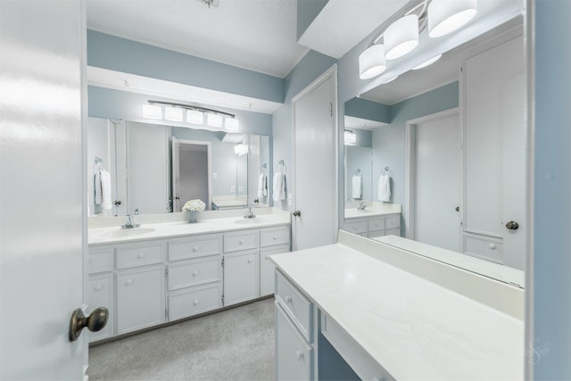 full bathroom with double vanity and a sink