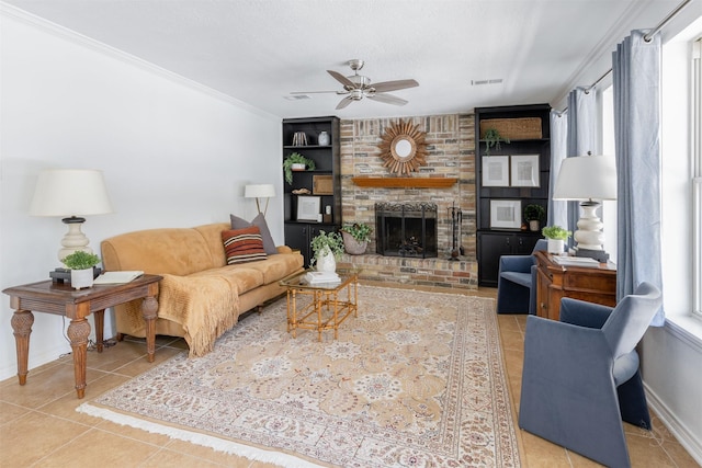 living room featuring visible vents, crown molding, a fireplace, and tile patterned floors