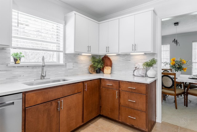 kitchen featuring dishwasher, light countertops, plenty of natural light, and a sink