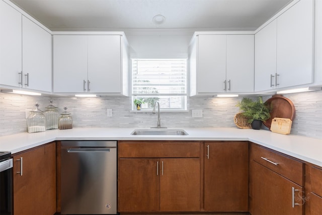 kitchen featuring light countertops, dishwasher, and a sink