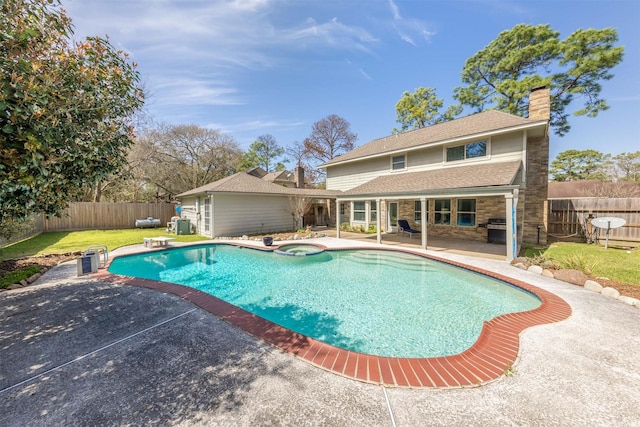 view of pool featuring a fenced backyard, a pool with connected hot tub, a diving board, and a patio