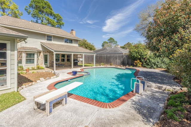 view of swimming pool with a fenced in pool, a patio area, a fenced backyard, and a diving board