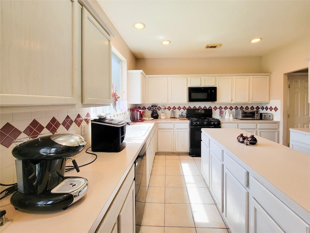 8002 Weeping Willow Pl, Missouri City, TX 77459 - kitchen with visible vents, black appliances, tasteful backsplash, light countertops, and light tile patterned floors