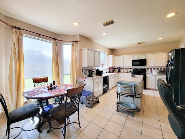8002 Weeping Willow Pl, Missouri City, TX 77459 - kitchen featuring visible vents, backsplash, light countertops, white cabinets, and black appliances