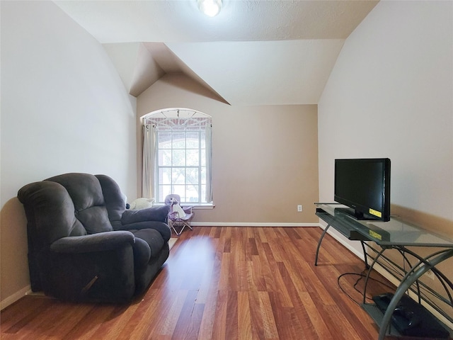8002 Weeping Willow Pl, Missouri City, TX 77459 - living area featuring lofted ceiling, wood finished floors, and baseboards