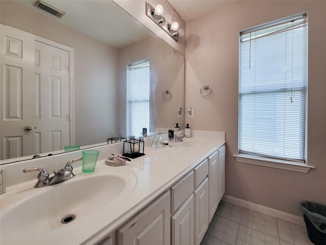 8002 Weeping Willow Pl, Missouri City, TX 77459 - bathroom featuring double vanity, visible vents, baseboards, and a sink