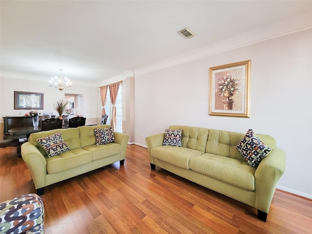 8002 Weeping Willow Pl, Missouri City, TX 77459 - living area with visible vents, wood finished floors, a chandelier, and crown molding