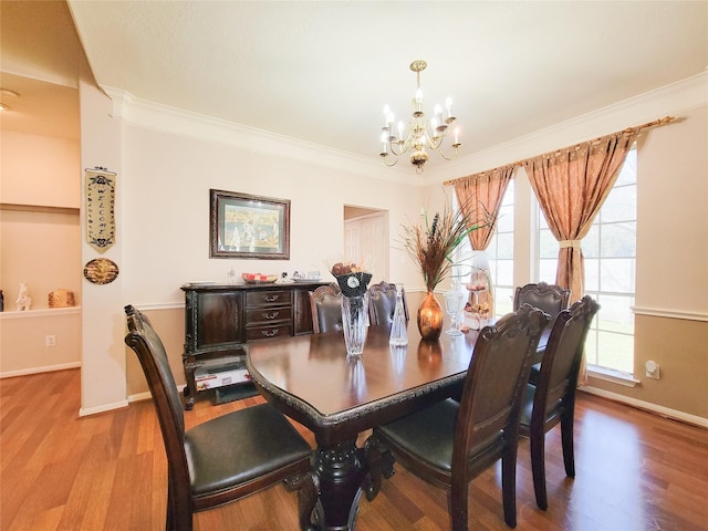 8002 Weeping Willow Pl, Missouri City, TX 77459 - dining room featuring a notable chandelier, wood finished floors, and crown molding