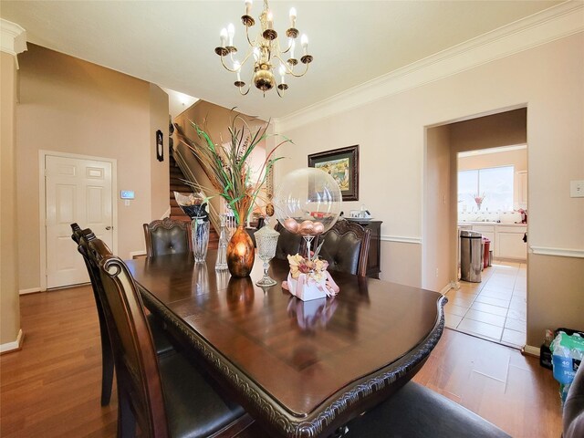8002 Weeping Willow Pl, Missouri City, TX 77459 - dining space with a notable chandelier, light wood-type flooring, and ornamental molding
