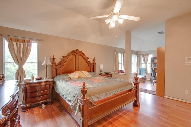 8002 Weeping Willow Pl, Missouri City, TX 77459 - bedroom featuring vaulted ceiling, multiple windows, and light wood-style floors