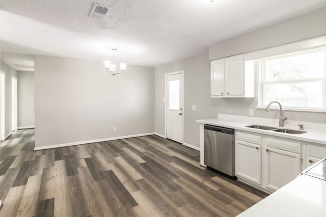 kitchen with a wealth of natural light, dark wood-style flooring, stainless steel dishwasher, white cabinets, and a sink