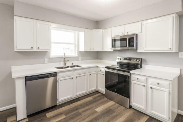 kitchen featuring white cabinets, stainless steel appliances, and a sink