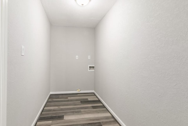 washroom featuring baseboards, washer hookup, wood finished floors, and laundry area