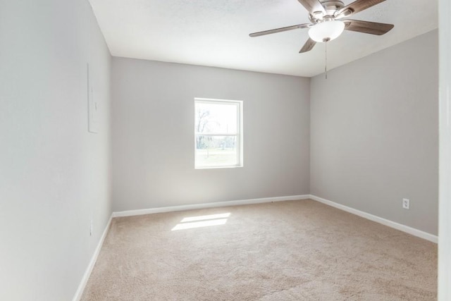 unfurnished room with baseboards, a ceiling fan, and carpet floors