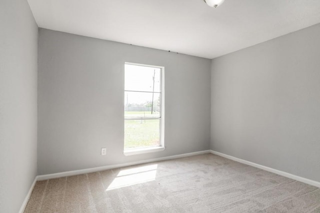 carpeted spare room with baseboards