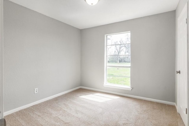 unfurnished room with baseboards and carpet floors