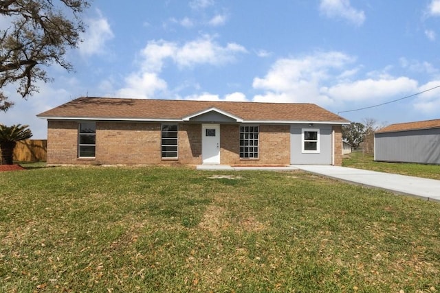 single story home with brick siding, a front yard, and fence