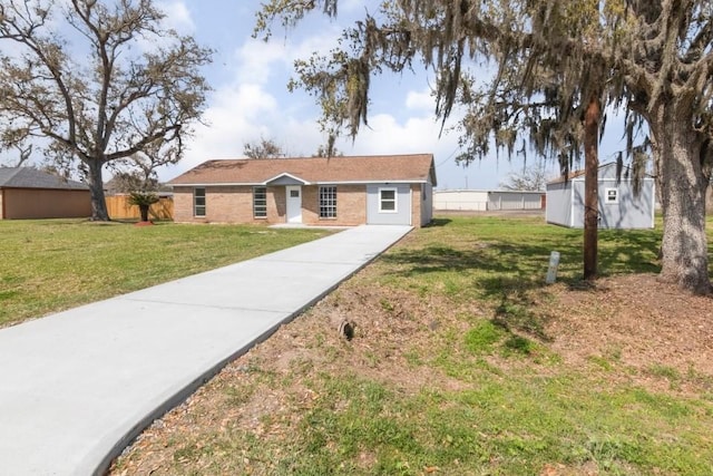 ranch-style home featuring a front lawn and fence