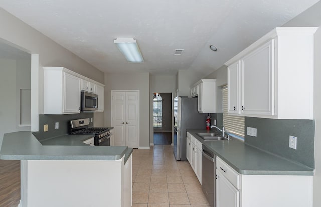 kitchen featuring light tile patterned floors, visible vents, stainless steel appliances, white cabinetry, and a sink