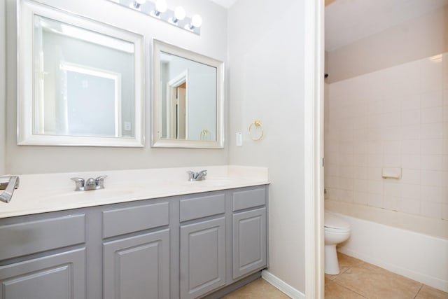 full bath with tile patterned flooring, a sink, toilet, and double vanity