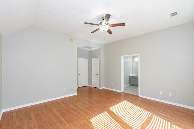 unfurnished bedroom featuring light wood-type flooring, visible vents, ensuite bath, and baseboards