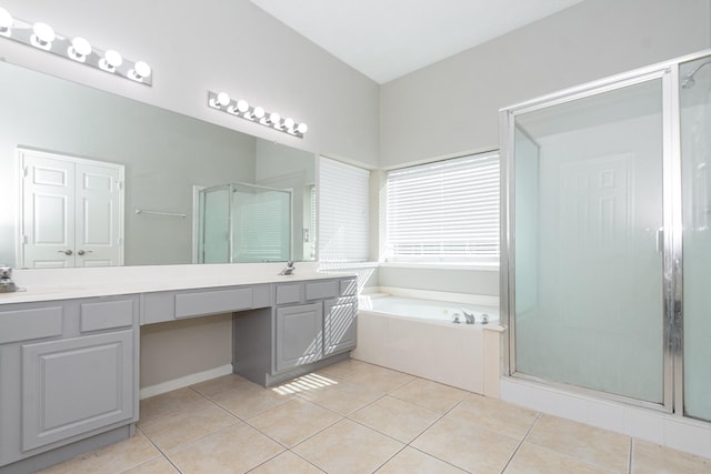 full bath with a garden tub, a shower stall, vanity, and tile patterned floors