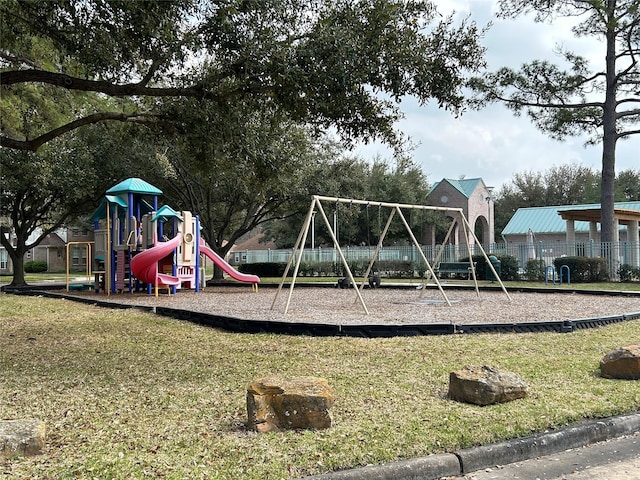 community playground featuring a lawn and fence