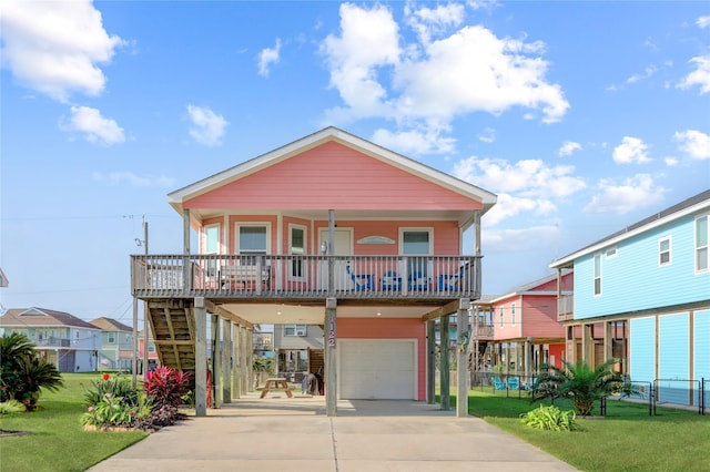 view of front of property featuring covered porch, an attached garage, a front yard, driveway, and stairs