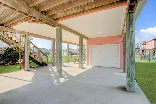 view of patio with a garage and stairs