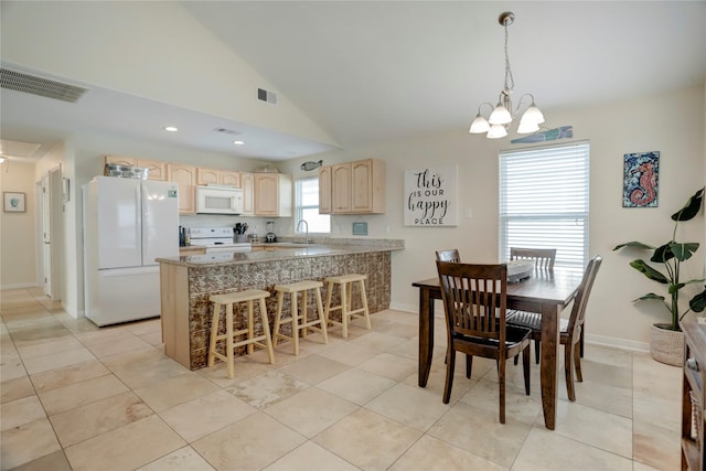 4122 Reeves Dr, Galveston, TX 77554 - dining area with a chandelier, light tile patterned floors, visible vents, and vaulted ceiling