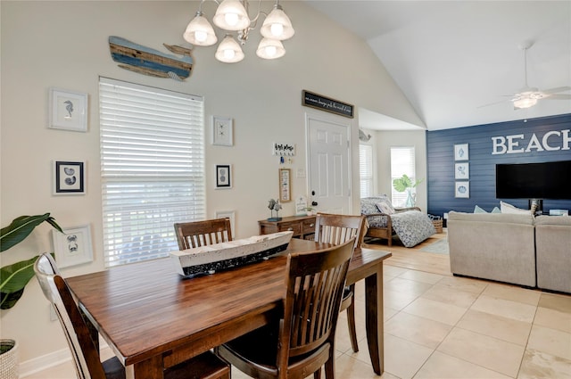 4122 Reeves Dr, Galveston, TX 77554 - dining room with light tile patterned floors, lofted ceiling, and ceiling fan with notable chandelier