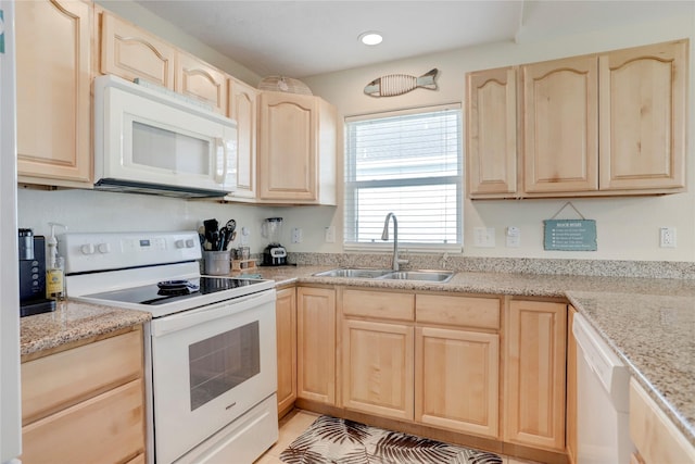 kitchen featuring light stone counters, recessed lighting, white appliances, a sink, and light brown cabinetry