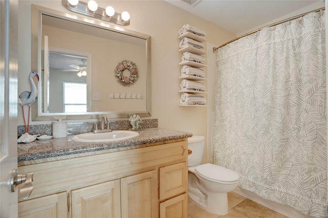 bathroom with tile patterned flooring, a shower with shower curtain, vanity, and toilet