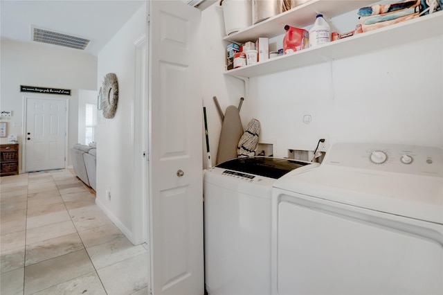 4122 Reeves Dr, Galveston, TX 77554 - clothes washing area featuring washer and dryer, laundry area, light tile patterned floors, and visible vents