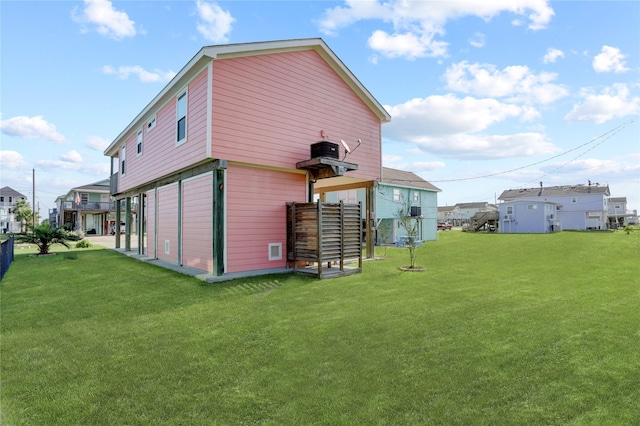 rear view of house featuring a yard