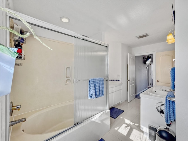 full bath with tile patterned flooring, visible vents, vanity, and enclosed tub / shower combo