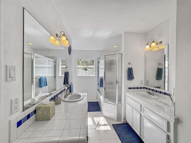 bathroom featuring tile patterned floors, two vanities, a shower with door, and a sink