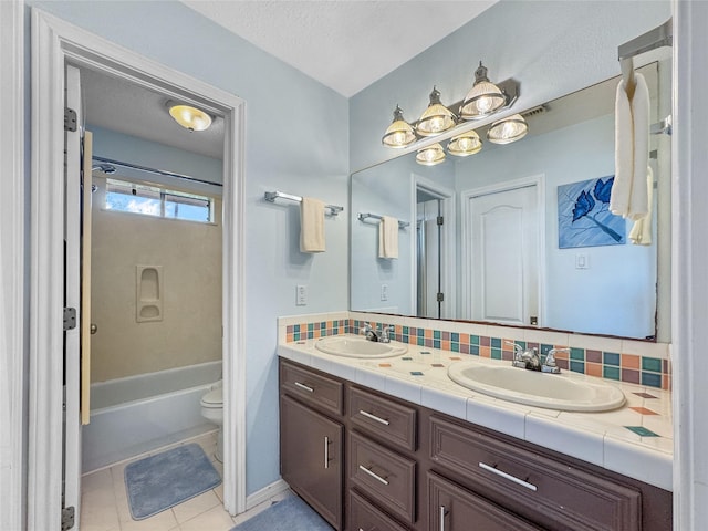 bathroom featuring a sink, tasteful backsplash, double vanity, and toilet