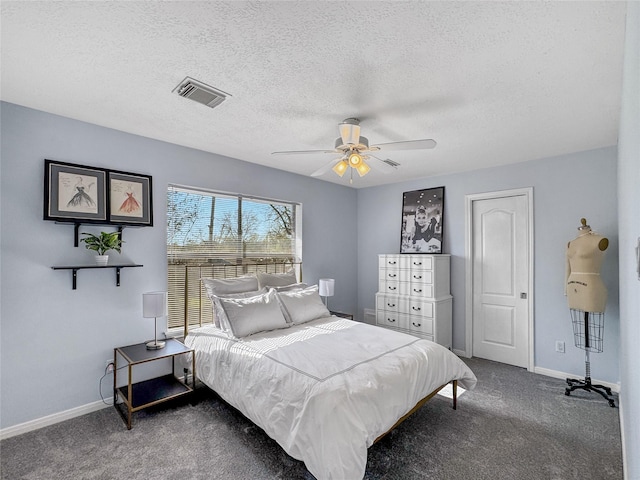 carpeted bedroom with visible vents, a textured ceiling, baseboards, and a ceiling fan