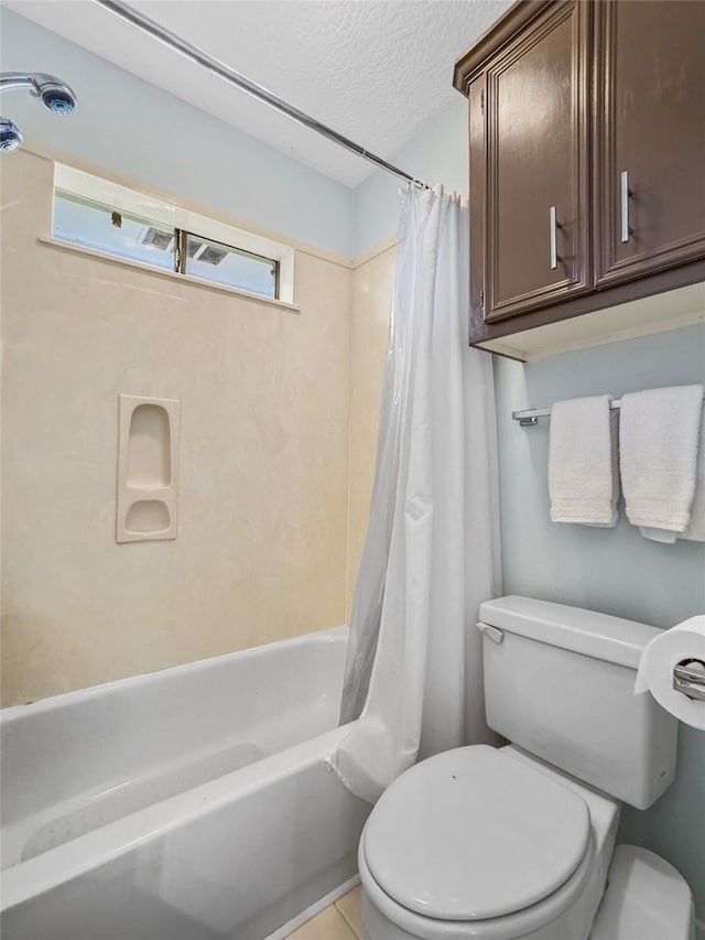 bathroom featuring tile patterned floors, shower / bath combination with curtain, a textured ceiling, and toilet