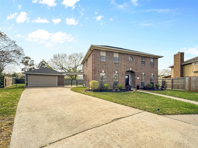 colonial home with fence, driveway, a front lawn, a garage, and brick siding