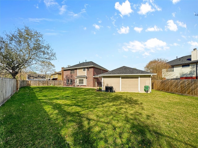 view of yard with an outbuilding, a fenced backyard, and a garage