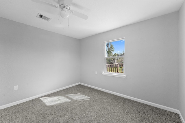 spare room featuring a ceiling fan, carpet, visible vents, and baseboards