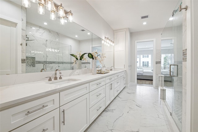 full bathroom featuring double vanity, a marble finish shower, visible vents, marble finish floor, and a sink