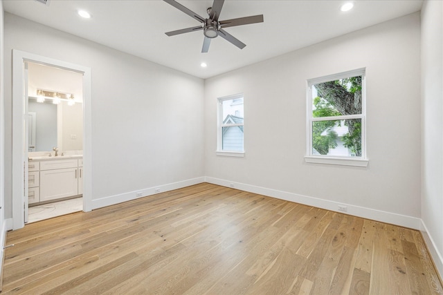 unfurnished bedroom with baseboards, ensuite bath, light wood-style flooring, and recessed lighting