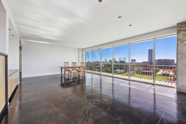 interior space featuring a wealth of natural light, a view of city, and expansive windows