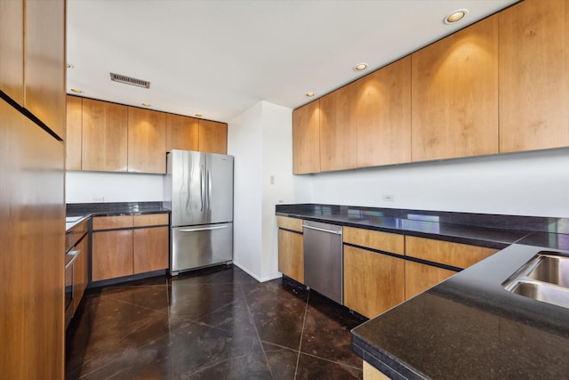 kitchen featuring recessed lighting, a sink, visible vents, appliances with stainless steel finishes, and brown cabinets