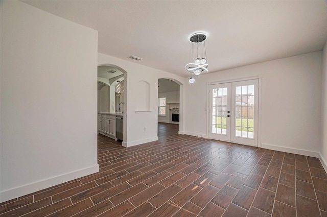 spare room featuring dark wood finished floors, baseboards, and visible vents